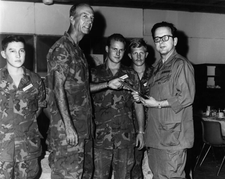 Senator Ted Stevens receives a momento of his trip to Vietnam, from 7th Marines Regimental Commander Col. Robert L. Nichols. Stevens and other senators made an inspection tour to South Vietnam in July of 1969. Stevens Foundation photo. Original file name 1969g12 from box 329-09-0083 462/565 a f-6