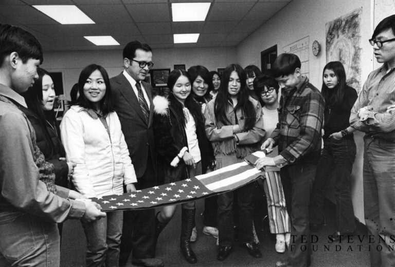 Sen. Ted Stevens visits students at the Rural Transition Center in Anchorage as they fold a flag he presented in honor of American Education Week on October 25, 1971. Folding are Jack Anowlic of Nome, left, and Dennis Trefon of Nondalton. Anchorage Times/Stevens Foundation photo