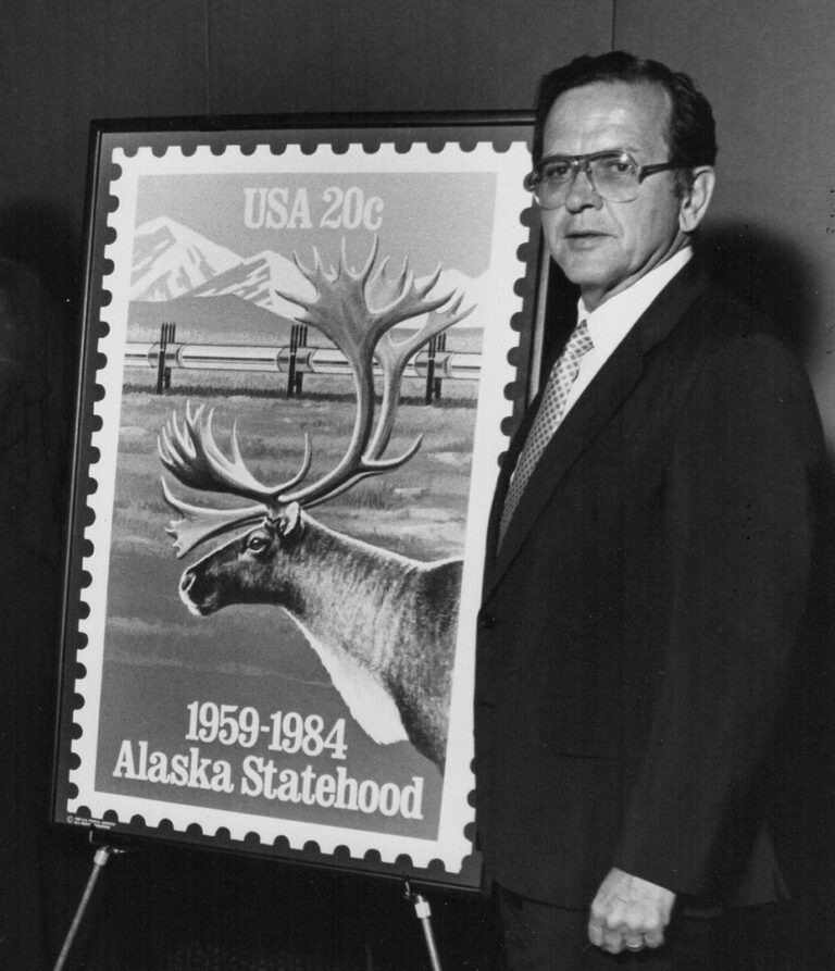 Sen. Ted Stevens with the postal stamp commemorating the 25th anniversary of Alaska Statehood in 1984. (This is a cropped version. The full version includes CS and Postmaster General William Bolger.) Stevens Foundation photo