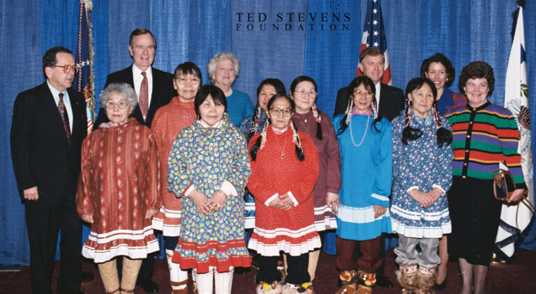 Senator Ted Stevens hosted a prayer breakfast in Washington DC attended by President George and Mrs. Barbara Bush, and Vice-President Dan and Mrs. Marilyn Quayle. The Savoonga Singers performed during the event on January 30, 1992. The singers are front, l-r, Margaret Kingeekuk, Janet Noogwook, Gertrude Toolie, Amelia Kingeekuk, Clarice Gologergen, Louisa Pungwiyi, Agatha Mokiyuk, Cecelia Noonwook, and escort Jeanne Dougherty. Stevens Foundation photo