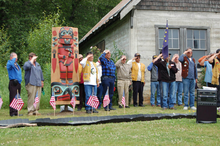 Sen. Ted Stevens and Chilkat Valley veterans, attended the dedication of new totems at Veteran's Memorial Park in Klukwan on July 5, 2008. From l-r, Ralph Strong, Bruce Smith, Joe King Jr., Donald Hotch Sr., Gene Strong, TS, James H. Stevens Sr., Bill Albecker (with flag), Bill Valentine, and James B. Strong. (Lori Stepansky/Stevens Foundation photo)